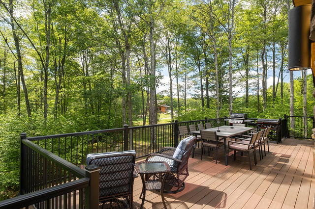 Bistro seating at the deck rail, looking out into the trees. Morning coffee happ