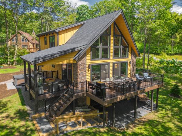 The back of the house from above — the deck, the covered deck below it, and the