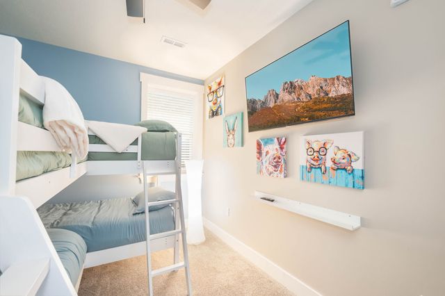 The bunk room set for the cousins — twin-over-twin, its own screen, walk-out ste