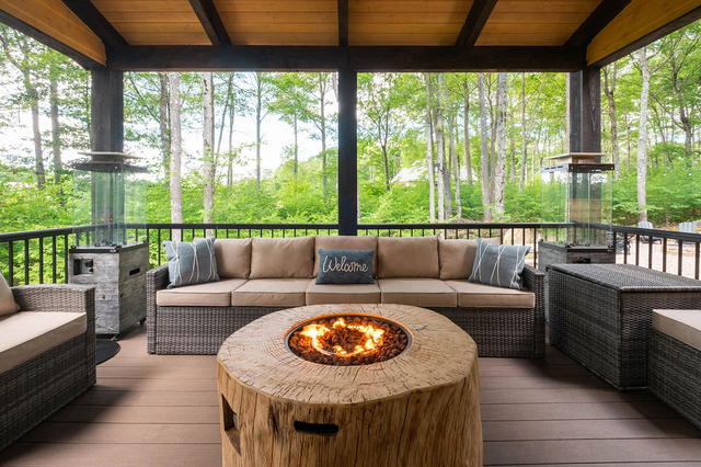 The covered deck and gas fire table in the trees