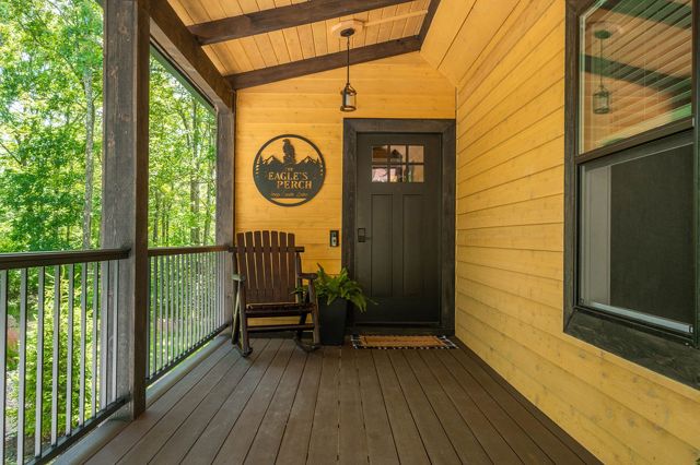 The covered front porch and the rocking chairs, looking down the drive into the 
